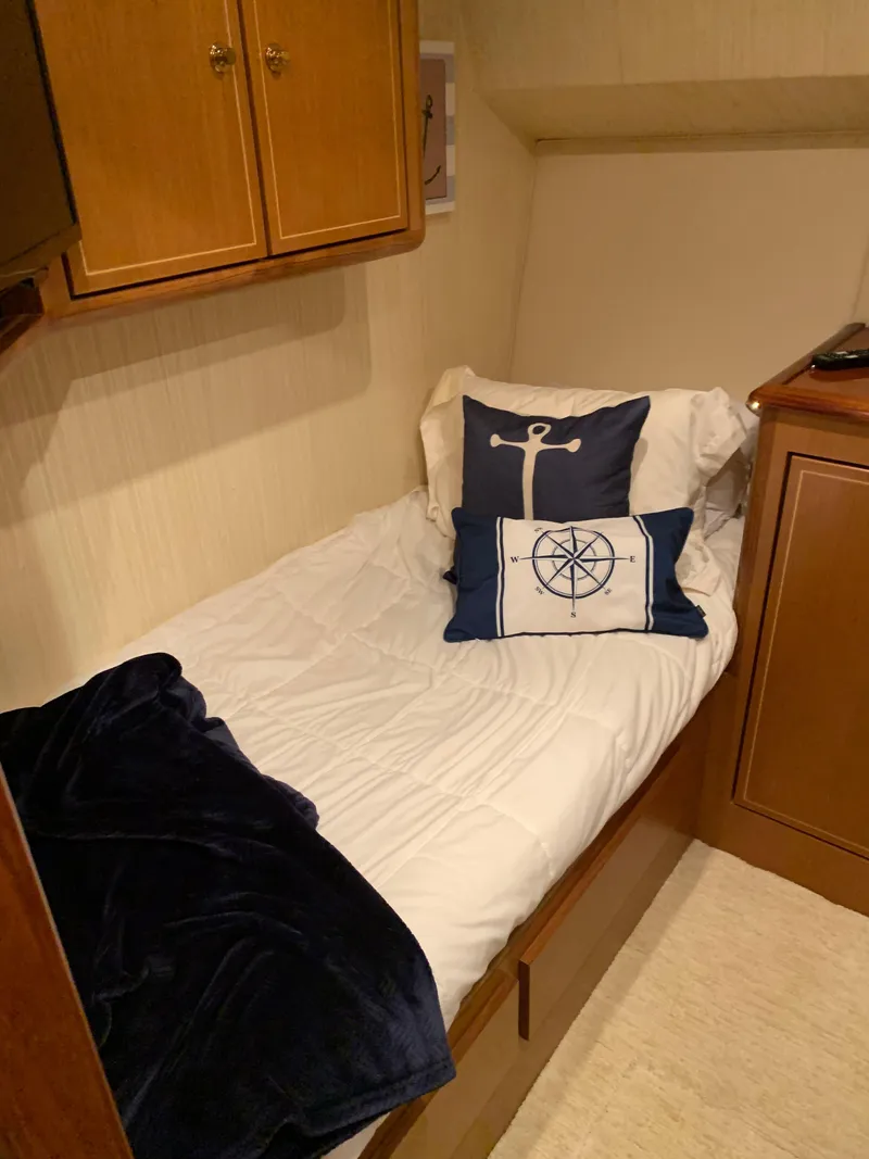 Slide: The Image of Cozy cabin bed in 2004 Ocean Yachts 57 Odyssey with nautical-themed pillows. - 47