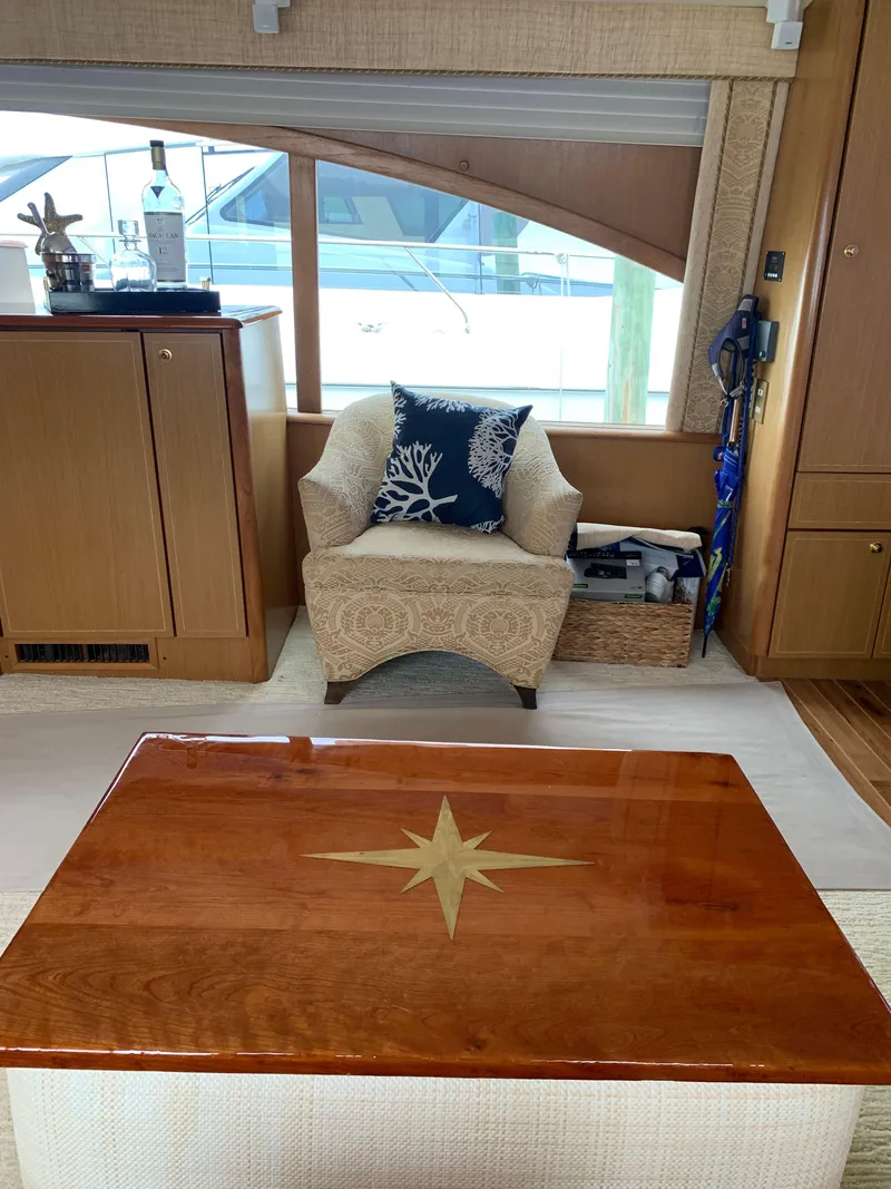 Slide: The Image of Luxurious interior of 2004 Ocean Yachts 57 Odyssey with elegant seating and wooden table. - 13