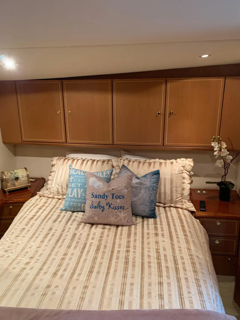 Slide: The Image of Cozy bedroom in 2004 Ocean Yachts 57 Odyssey with nautical-themed pillows and wooden cabinets. - 27