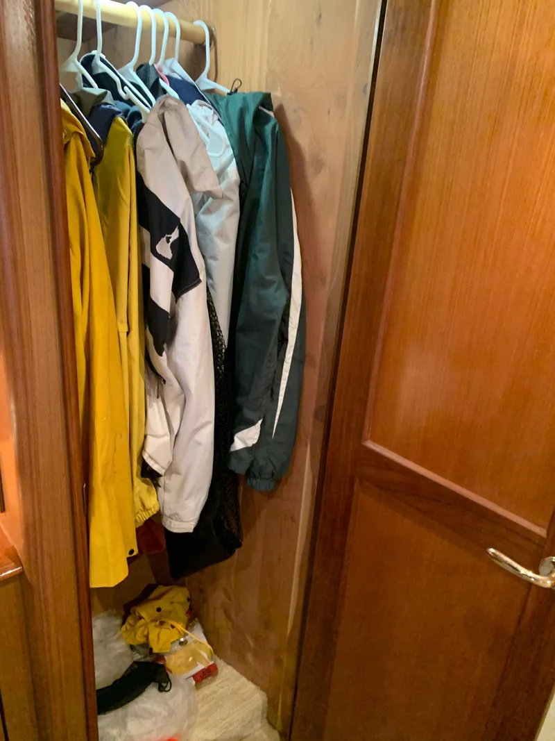 Slide: The Image of Closet with jackets inside 2004 Ocean Yachts 57 Odyssey. - 32