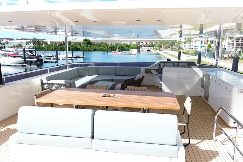 Slide: The Image of Luxurious Granocean W72 yacht deck with seating, table, and marina view, 2025 model. - 10