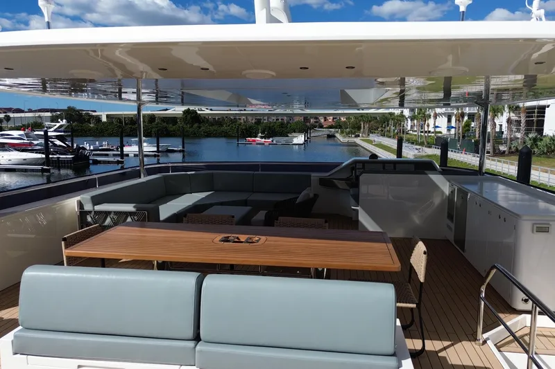 Slide: The Image of Luxurious Granocean W72 yacht deck with seating, table, and scenic marina view, 2025 model. - 11