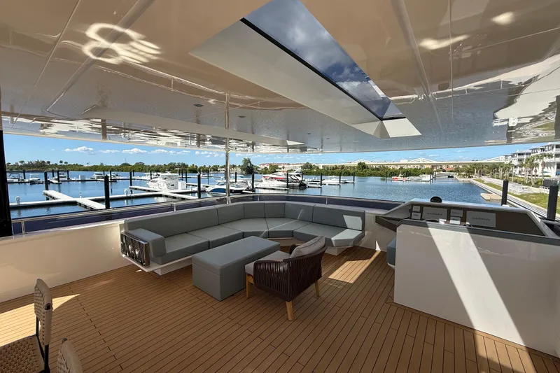 Slide: The Image of Luxurious Granocean W72 yacht interior with modern seating, overlooking marina, 2025 model. - 14
