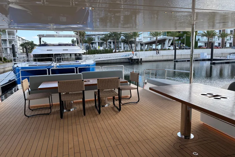 Slide: The Image of Luxurious Granocean W72 yacht deck with elegant seating, docked in a serene marina, 2025 model. - 16