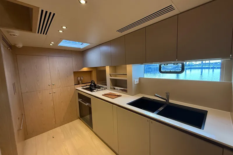 Slide: The Image of Modern kitchen interior of 2025 Granocean W72 yacht, featuring sleek cabinetry and waterfront view. - 22