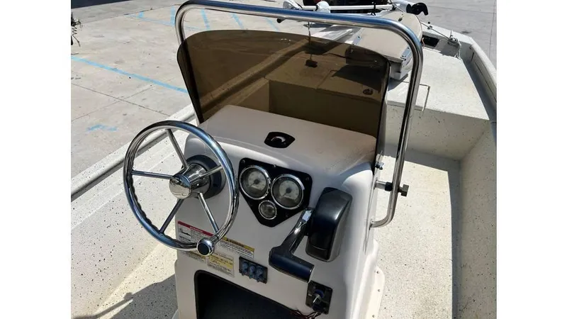 Slide: The Image of 2014 Express XP 18 CC boat console with steering wheel and gauges. - 7