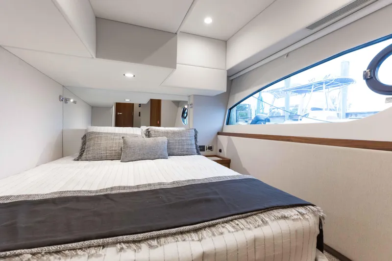 Slide: The Image of Luxurious bedroom interior of 2025 Riviera 46 Sport Motor Yacht with modern design. - 23