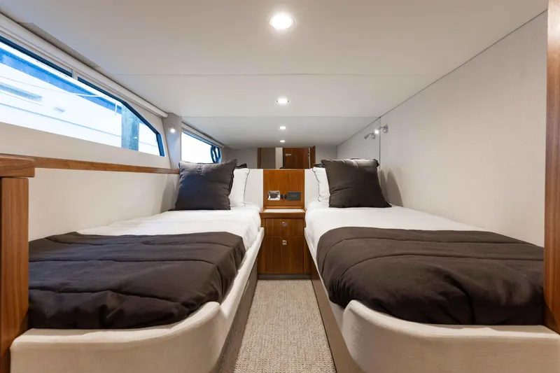 Slide: The Image of Interior of 2025 Riviera 46 Sport Motor Yacht with twin beds and modern design. - 24