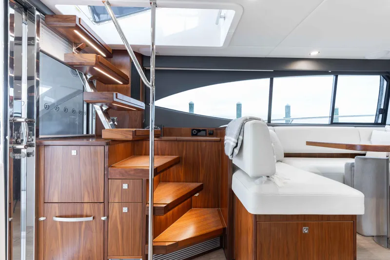 Slide: The Image of Interior of 2025 Riviera 46 Sport Motor Yacht with elegant wood finishes and modern seating. - 29