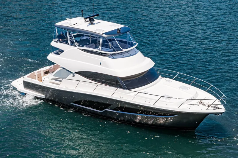 Slide: The Image of 2025 Riviera 46 Sport Motor Yacht cruising on open water. - 3