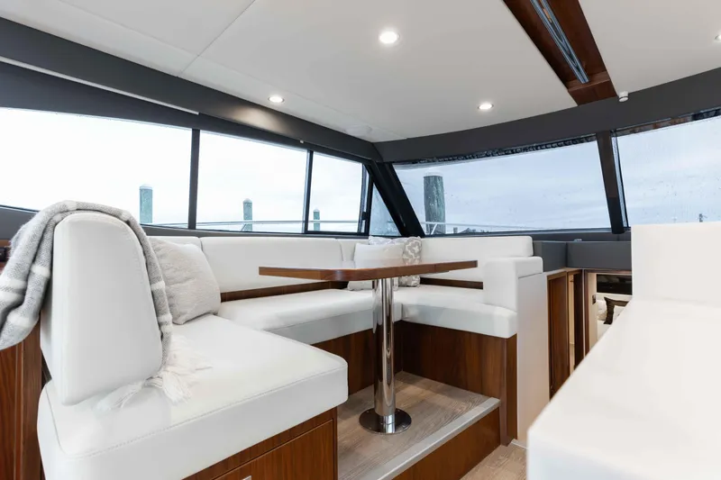 Slide: The Image of Luxurious interior of 2025 Riviera 46 Sport Motor Yacht with elegant seating and panoramic windows. - 30