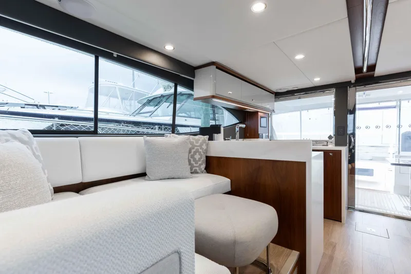 Slide: The Image of Luxurious interior of 2025 Riviera 46 Sport Motor Yacht with modern seating and large windows. - 35