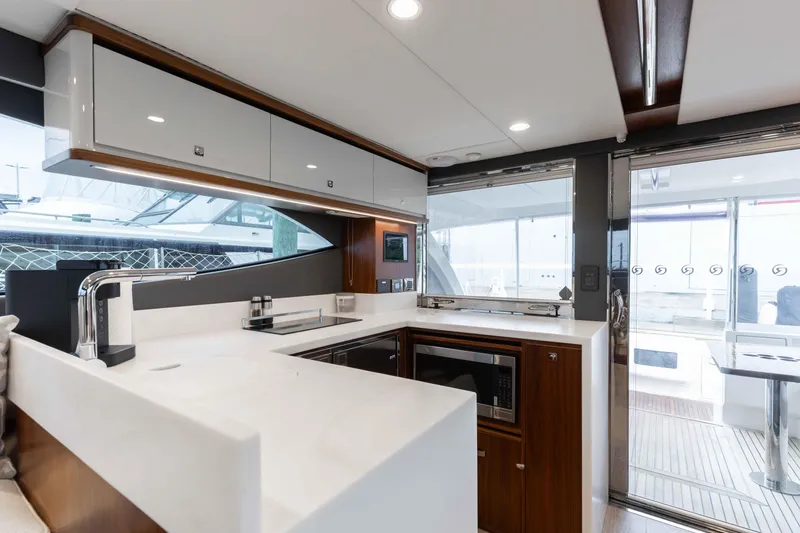 Slide: The Image of Modern kitchen interior of 2025 Riviera 46 Sport Motor Yacht, featuring sleek design and appliances. - 36