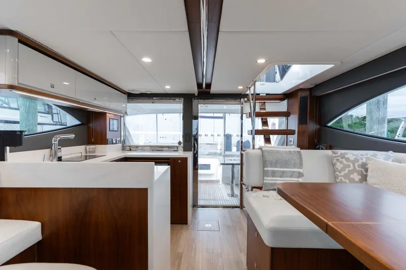 Slide: The Image of Luxurious interior of 2025 Riviera 46 Sport Motor Yacht with modern kitchen and seating area. - 37