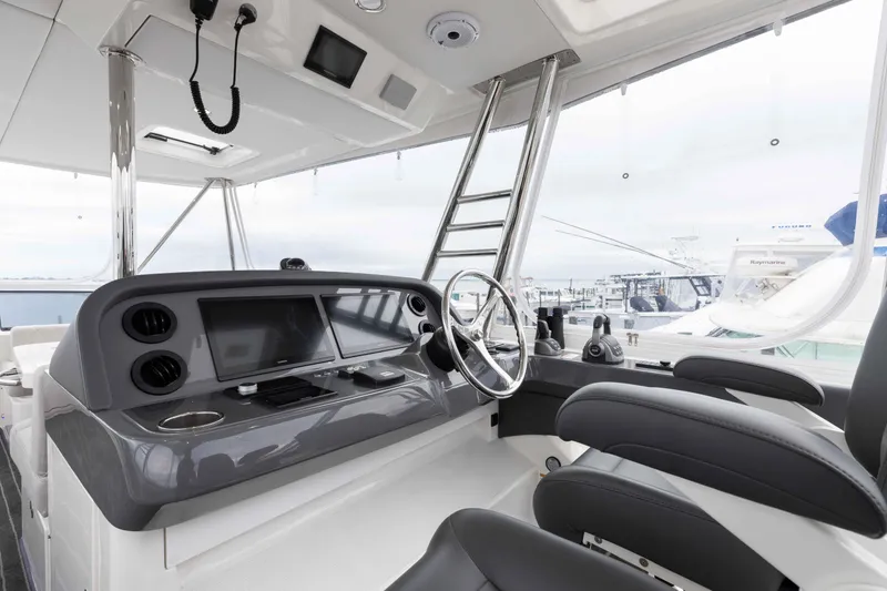 Slide: The Image of 2025 Riviera 46 Sport Motor Yacht helm with modern controls and sleek design. - 40