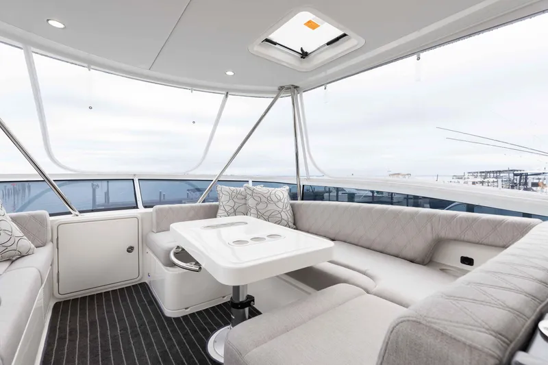 Slide: The Image of Luxurious interior of 2025 Riviera 46 Sport Motor Yacht with elegant seating and table. - 43