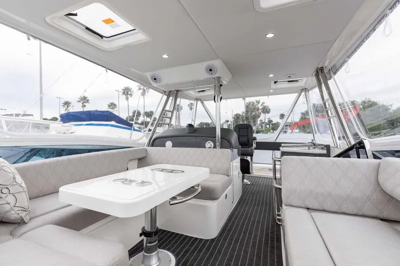 Slide: The Image of Luxurious interior of 2025 Riviera 46 Sport Motor Yacht with elegant seating and dining area. - 44
