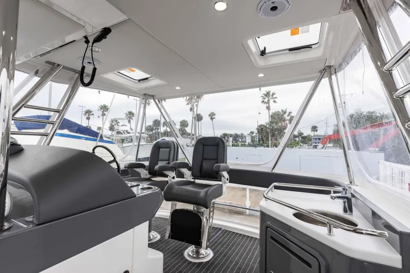 Slide: The Image of Interior of 2025 Riviera 46 Sport Motor Yacht with modern seating and controls. - 45
