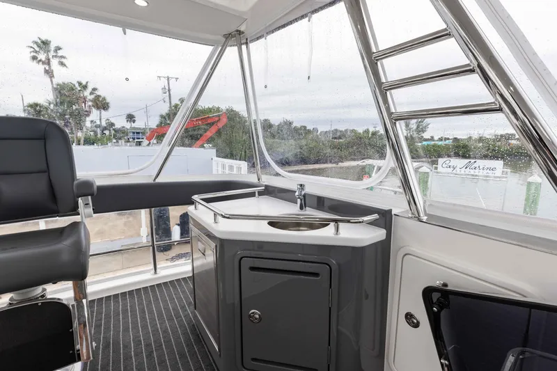 Slide: The Image of 2025 Riviera 46 Sport Motor Yacht interior with sleek sink and seating area. - 46