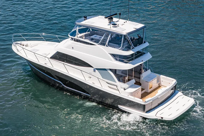 Slide: The Image of 2025 Riviera 46 Sport Motor Yacht cruising on open water. - 5