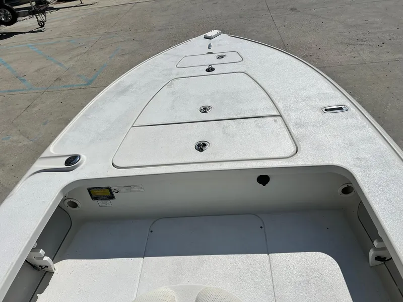 Slide: The Image of 2009 Ranger 184 Ghost boat deck with storage compartments in a parking area. - 10