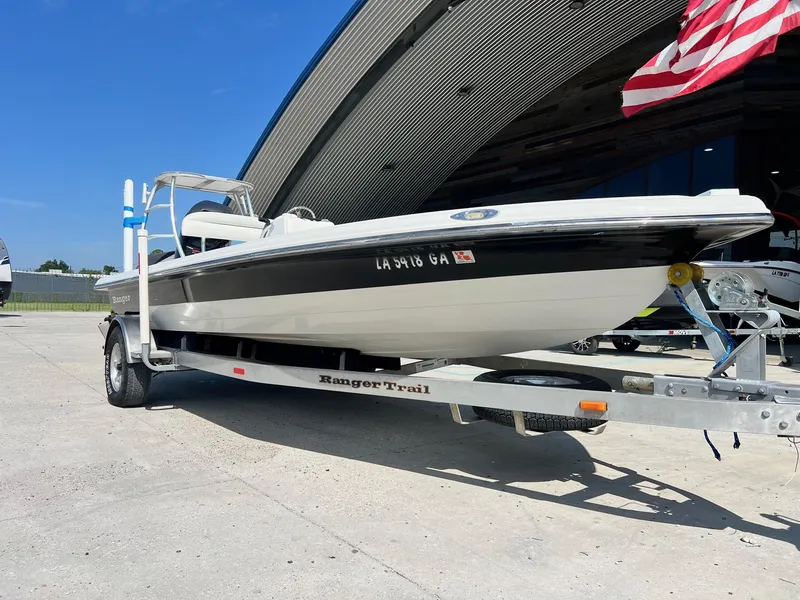 Slide: The Image of 2009 Ranger 184 Ghost boat on trailer, parked outdoors under clear sky. - 2