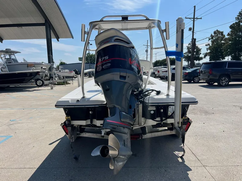 Slide: The Image of 2009 Ranger 184 Ghost boat with outboard motor in a parking lot. - 4