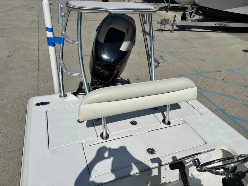 Slide: The Image of 2009 Ranger 184 Ghost boat with motor and seating, parked on concrete. - 6