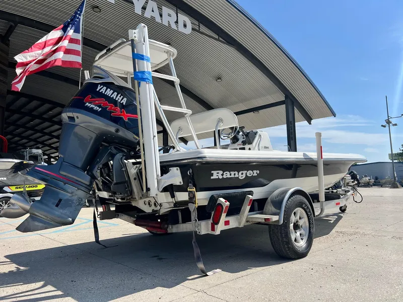 Slide: The Image of 2009 Ranger 184 Ghost boat with Yamaha engine, parked under a canopy. - 9