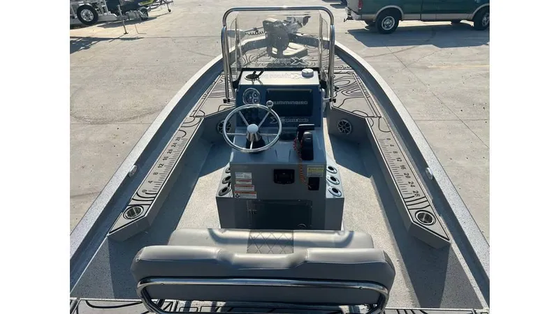 Slide: The Image of 2023 Express H22B boat interior with steering console and seating. - 4