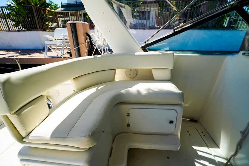 Slide: The Image of 1998 Tiara Yachts 3100 Open interior with white seating and storage compartment. - 11