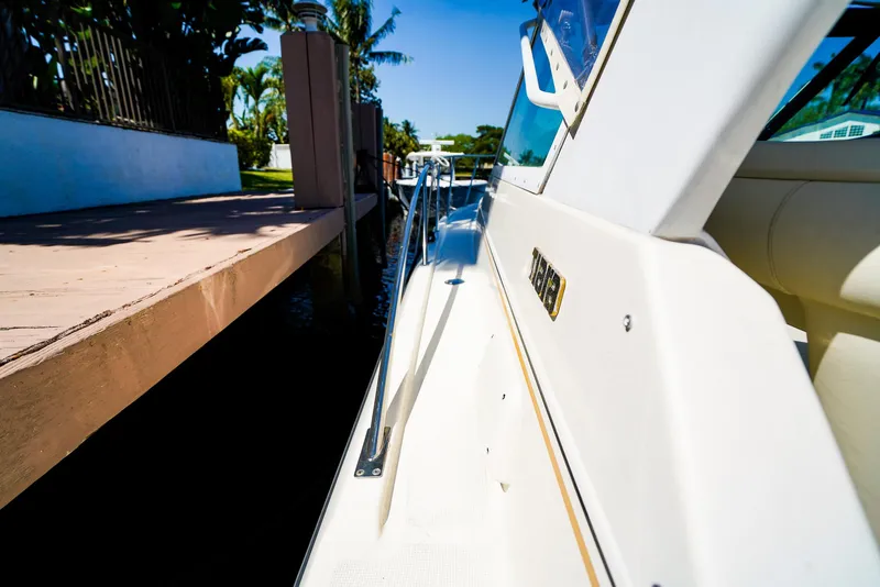 Slide: The Image of 1998 Tiara Yachts 3100 Open docked, showcasing sleek design and luxurious detailing. - 15