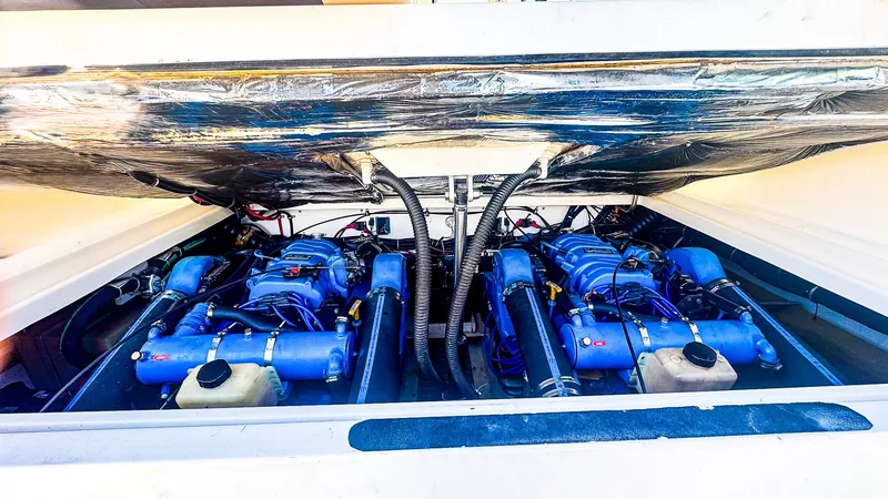 Slide: The Image of Engine compartment of a 1998 Tiara Yachts 3100 Open, showcasing dual blue engines. - 19