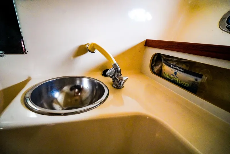 Slide: The Image of 1998 Tiara Yachts 3100 Open sink area with faucet and storage compartment. - 21