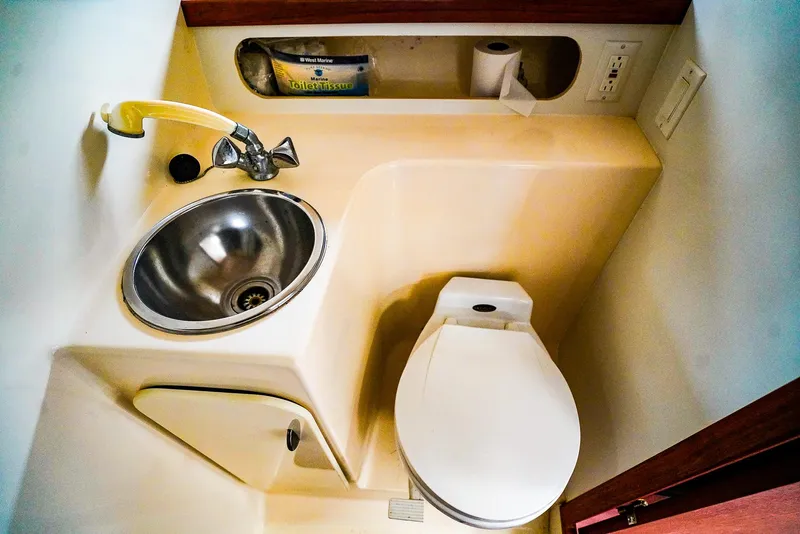 Slide: The Image of Compact bathroom in 1998 Tiara Yachts 3100 Open, featuring sink and toilet. - 22