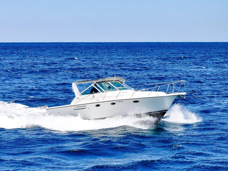 Slide: The Image of 1998 Tiara Yachts 3100 Open cruising on blue ocean waters. - 3