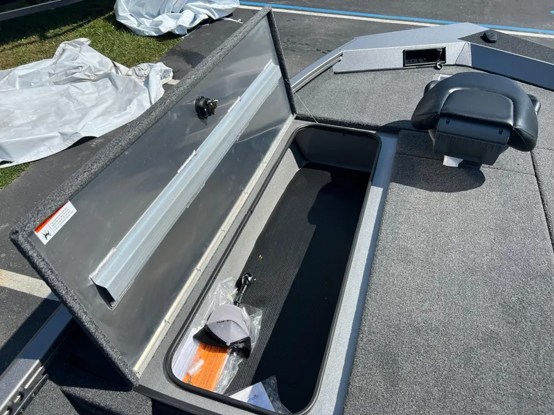 Slide: The Image of 2024 Crestliner XF 189 boat storage compartment with open lid and accessories. - 6