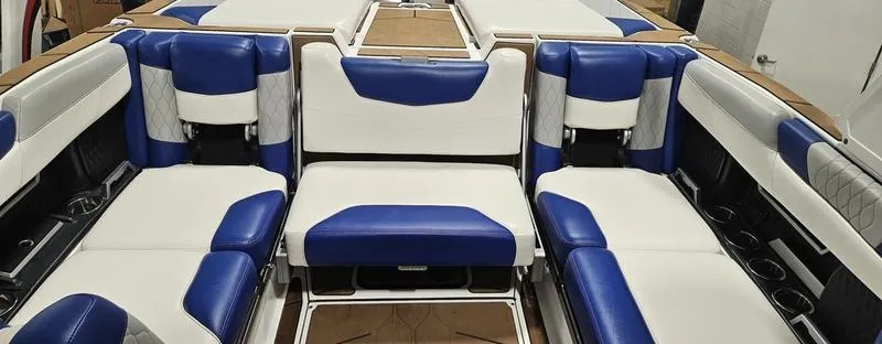 Slide: The Image of 2020 Malibu M240 boat interior with blue and white seating arrangement. - 15