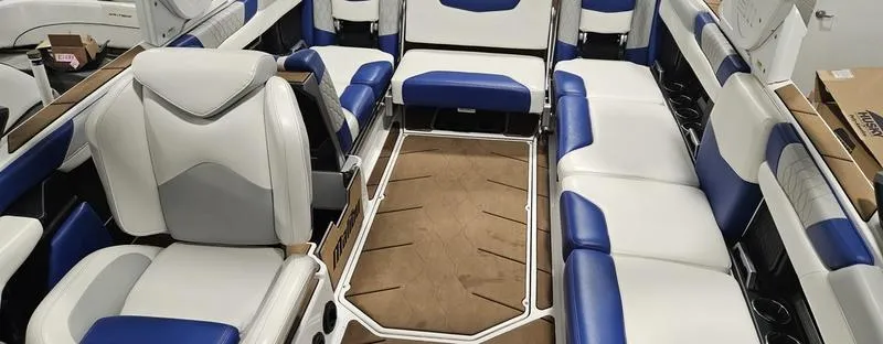 Slide: The Image of Interior of 2020 Malibu M240 boat with white and blue seating. - 16