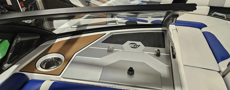Slide: The Image of 2020 Malibu M240 boat interior with sleek design, featuring blue and white seating. - 18