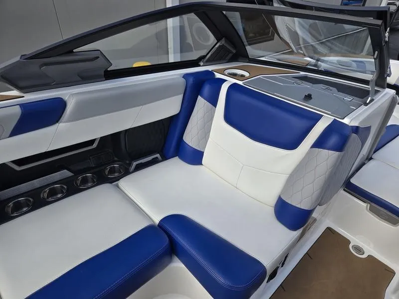 Slide: The Image of 2020 Malibu M240 boat interior with blue and white seating, modern design. - 24