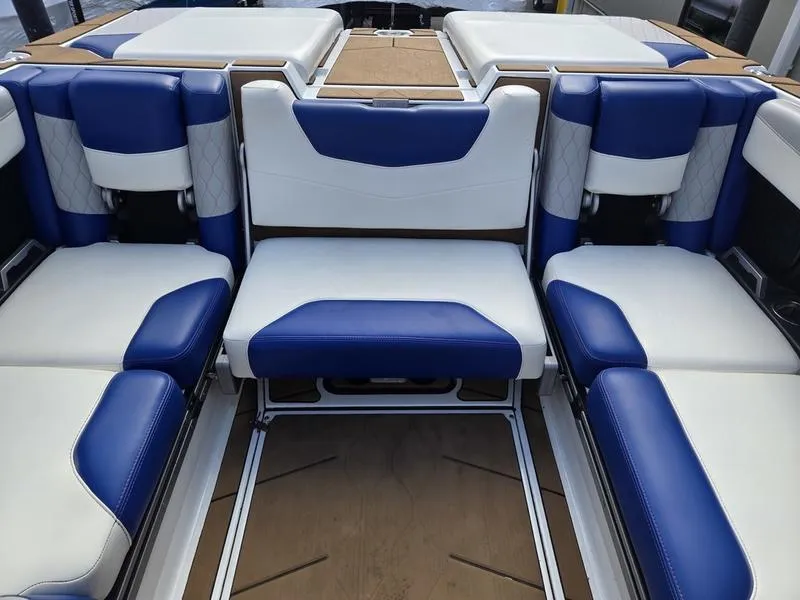 Slide: The Image of Interior seating of 2020 Malibu M240 boat with blue and white upholstery. - 26