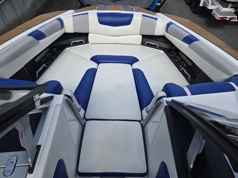 Slide: The Image of 2020 Malibu M240 boat interior with blue and white seating arrangement. - 27