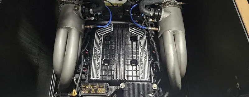 Slide: The Image of 2020 Malibu M240 engine compartment with dual exhaust manifolds and detailed components. - 8