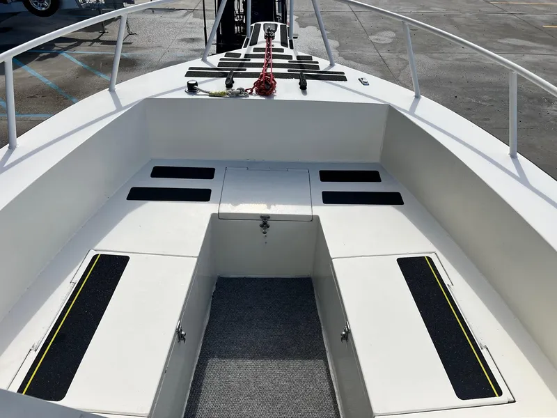 Slide: The Image of 1993 Gravois 23 DC boat interior with white seating and storage compartments. - 12