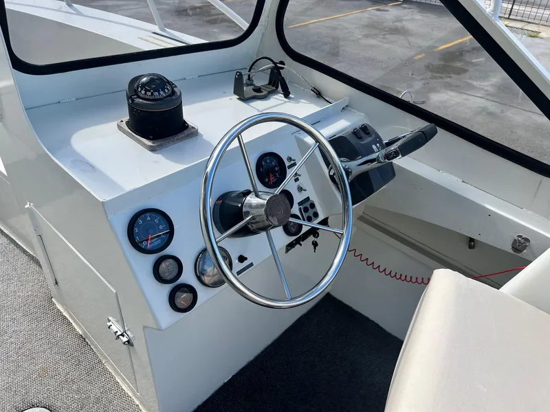 Slide: The Image of 1993 Gravois 23 DC boat dashboard with steering wheel and gauges. - 4