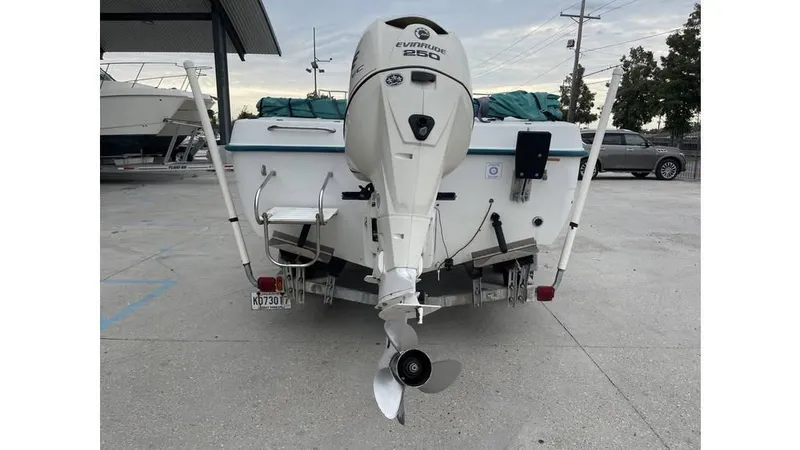 Slide: The Image of 1998 Sunbird 230 CC boat with Evinrude engine on trailer at boat yard. - 2
