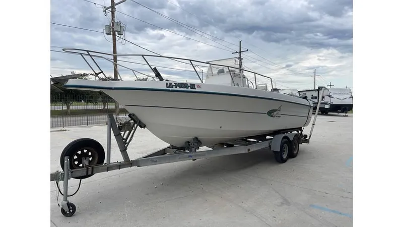 Slide: The Image of Overhead view of a 1998 Sunbird 230 CC boat on a concrete surface. - 4
