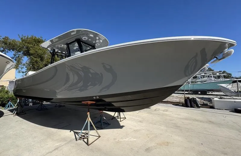 The Image of 2025 Sportsman Open 282 boat on stands, sleek design, outdoor display. - 1