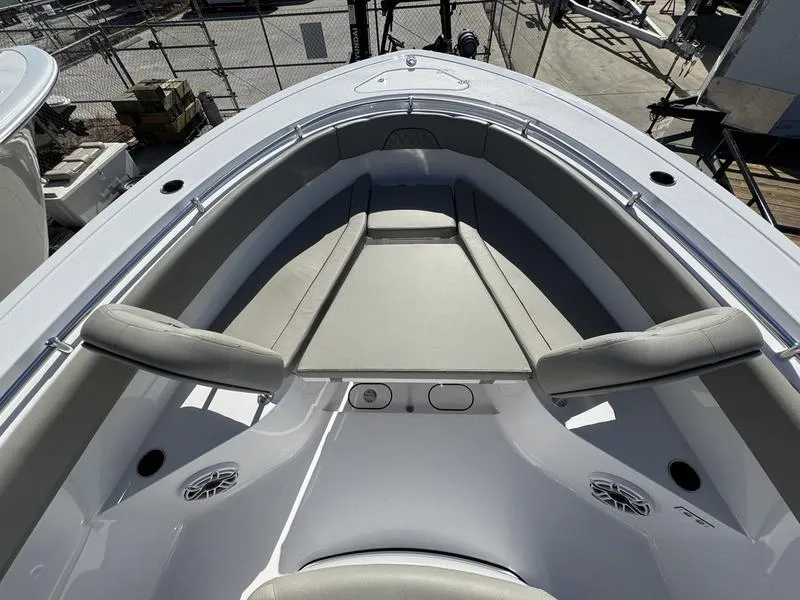 Slide: The Image of 2025 Sportsman Open 282 boat interior with cushioned seating and speakers. - 10